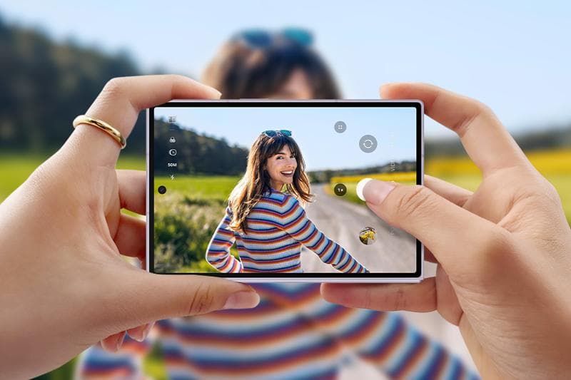 Galaxy Z Fold8 held folded and sideways in two hands, using the cover screen as a camera viewfinder with the 50MP mode selected