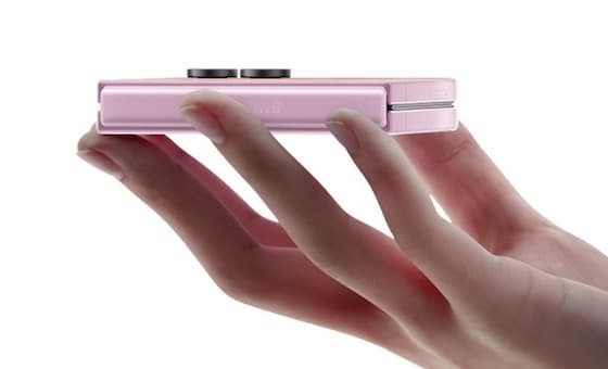Galaxy Z Flip8 closed and seen edge-on across a palm, showing the hinge seam and how thick the phone is when folded