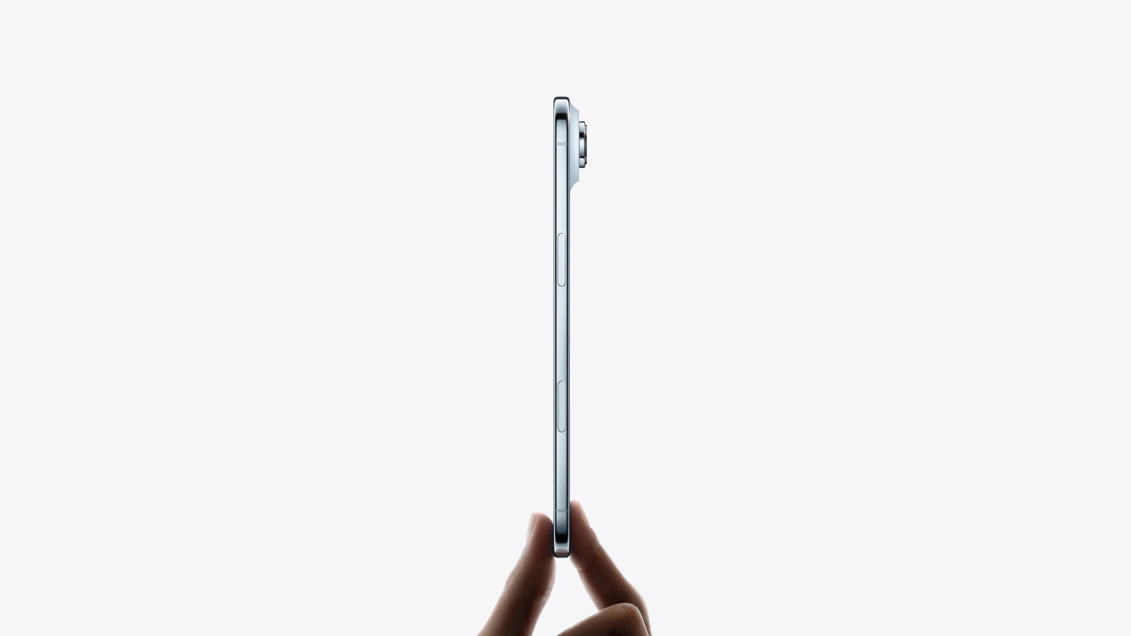 An iPhone Air held edge-on between two fingers, showing how thin the body is from the side