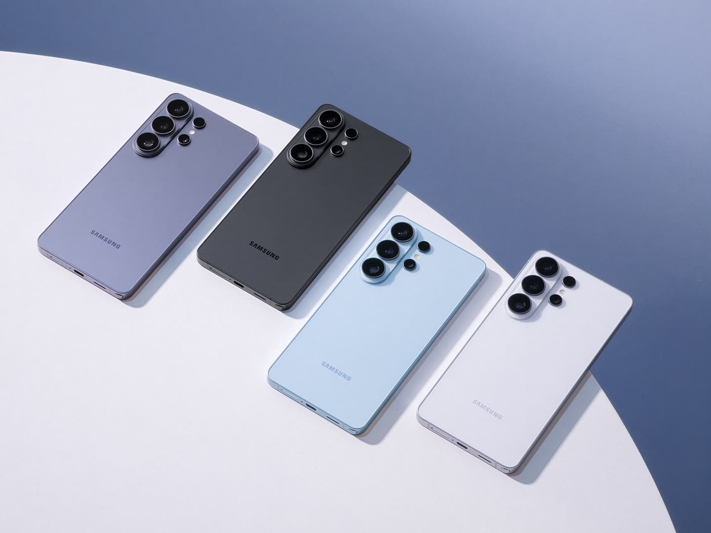 Four Samsung Galaxy S26 Ultra phones from the back in Cobalt Violet, Black, Sky Blue and White, showing the four-lens camera island