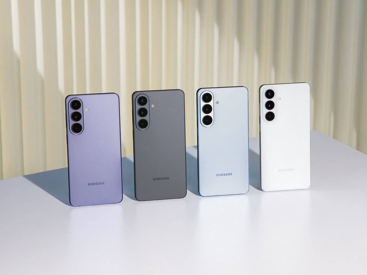 Samsung Galaxy S26 from the back in four colours, showing the three-lens camera island